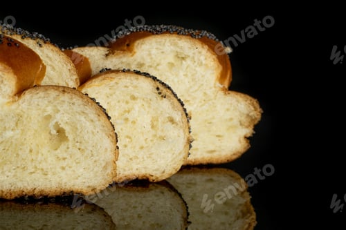 Preview: Closeup Of Three Slices Of Twisted Poppy Seed Bun In Row Isolated On Black Glass