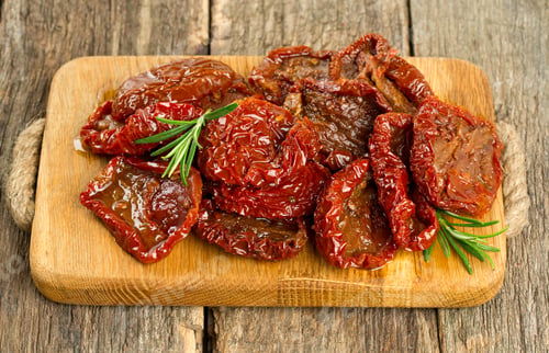 Preview: Sun Dried Tomatoes With Olive Oil On Wooden Surface