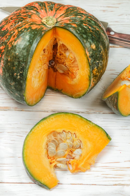 Preview: Pumpkin. Pieces On White Wooden Table. Culinary Background