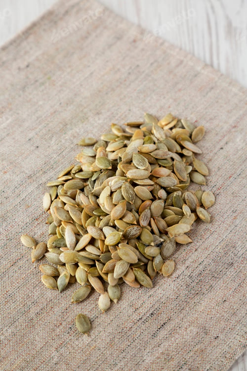 Preview: Roasted Pumpkin Seeds On Cloth, Low Angle View. Closeup.