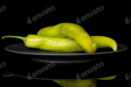 Preview: Group Of Two Whole Hot Green Pepper Banana On Gray Ceramic Plate Isolated On Black Glass