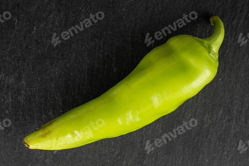 Preview: One Whole Hot Green Pepper Banana Flatlay On Grey Stone