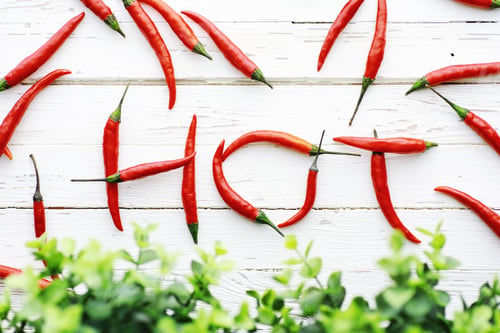 Preview: Hot Red Pepper On White Wooden Vintage Background.