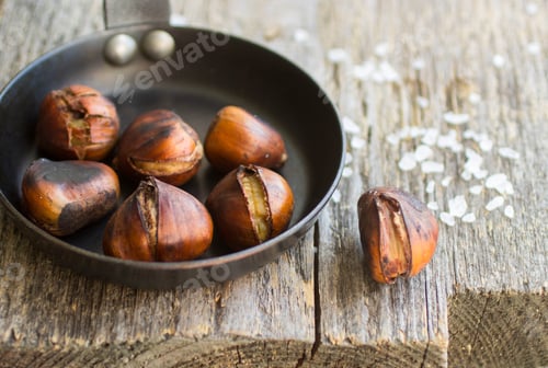 Preview: Roasted Chestnuts On Wooden Table With Coarse Salt