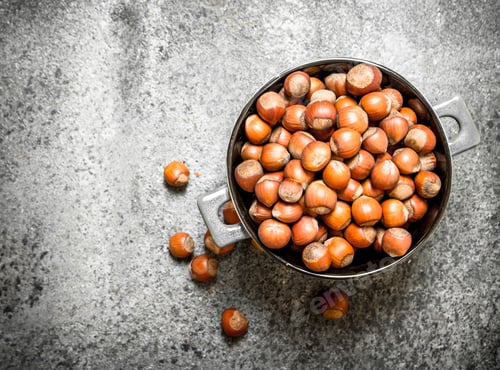 Preview: Hazelnuts In A Bowl. On Rustic Background.