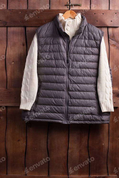 Preview: Beautiful White Knitted Sweater And Vest Hanging On A Wooden Fence.