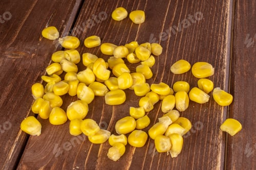 Preview: Lot Of Pieces Of Canned Yellow Corn On Brown Wood