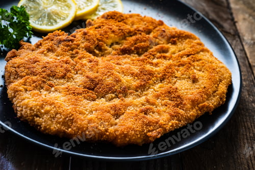 Preview: Schnitzel With Lemon On Wooden Background