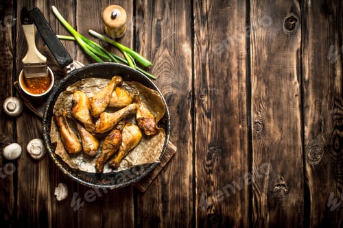 Preview: Fried Chicken Legs With Tomato Sauce. On A Wooden Table.