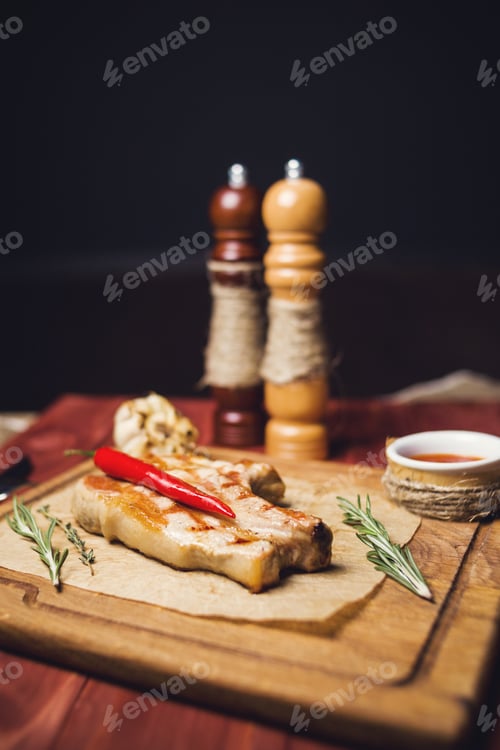 Preview: Roasted Beef Rib With Pepper And Rosemary On Wooden Board
