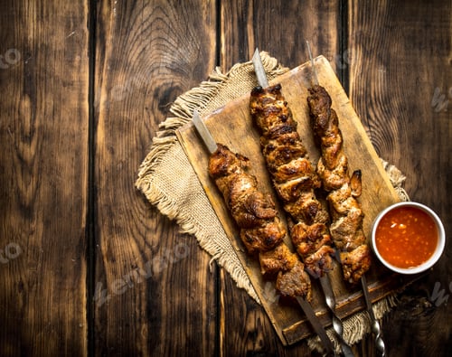 Preview: Kebab With Tomato Sauce. On Wooden Background.