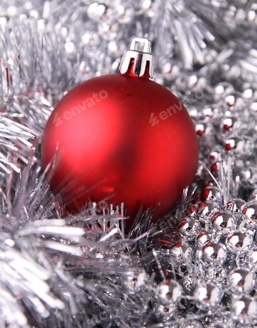 Festive Red Bauble Surrounded by Silver Tinsel