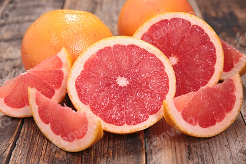 Fresh Grapefruit Slices on a Rustic Wooden Surface