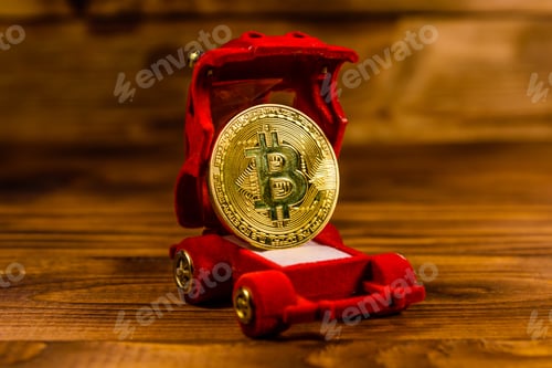 Preview: Golden Bitcoin In Car-Shaped Gift Box For Jewelry On Wooden Table