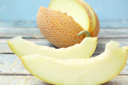 Preview: One Cut Fresh Ripe Melon On A Wooden Background