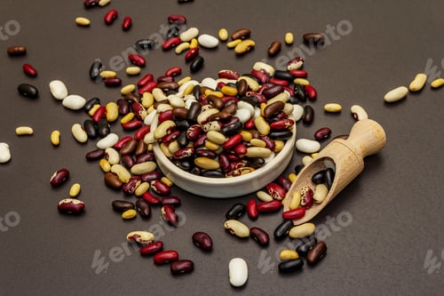Preview: Assorted Different Types Of Beans In Ceramic Bowl. Mix Of Various Dry Legumes Scattered On Black