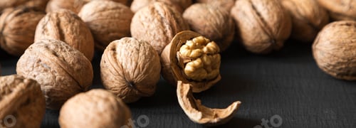 Preview: Halved And Whole Walnuts On Black Background, Side View. Closeup.