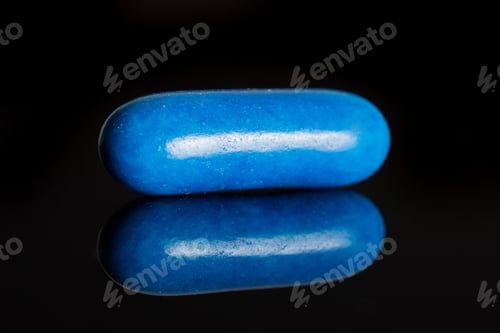 Preview: One Whole Blue Sweet Licorice Comfit Isolated On Black Glass