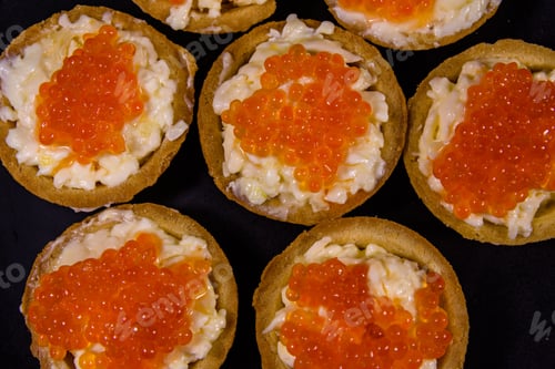 Preview: Tartlets With Red Caviar On Black Plate. Festive Food. Top View