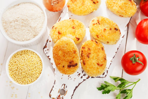 Preview: Homemade Millet Patties On A Wooden Table