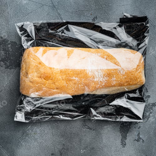 Preview: Loaf Of Fresh Baked Artisan Whole Grain Ciabatta Bread In A Market Bag, On Gray Background, Top