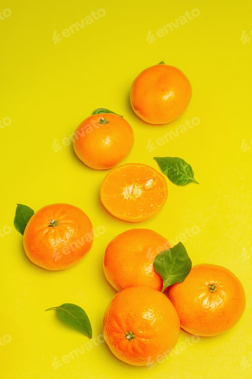 Preview: Ripe Juicy Tangerines And Fresh Leaves. Sunny Summer Yellow Background, Close Up