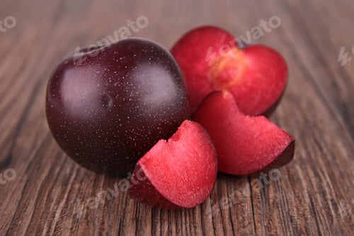 Fresh Plum with Slices on Wooden Table
