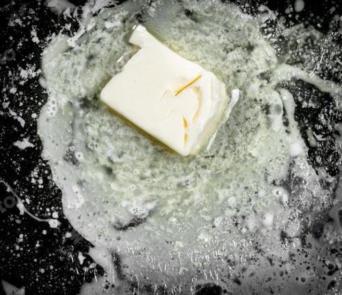 Preview: Butter In An Old Pan. On Rustic Background.