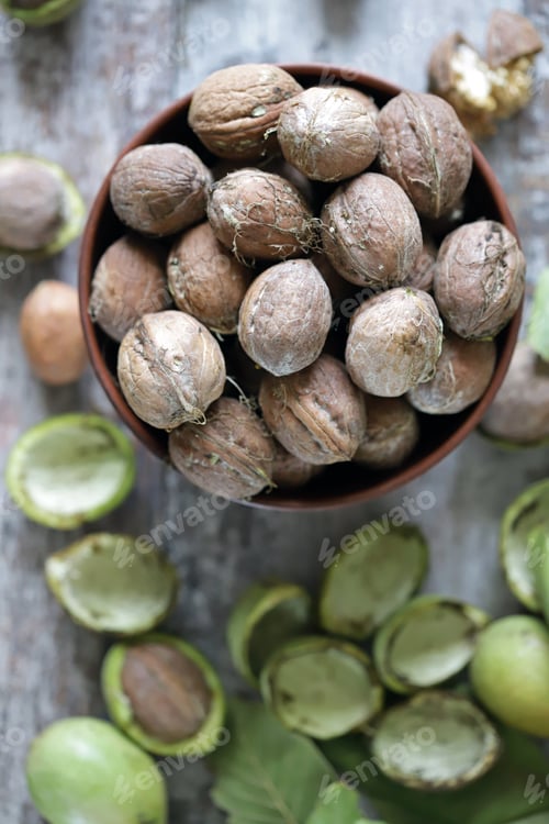 Preview: Freshly Walnuts In A Bowl. Harvest Walnuts. Walnuts Peeled From Green Shells. The Leaves Of The