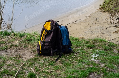 Preview: Backpacks On A Green Bank Of The River