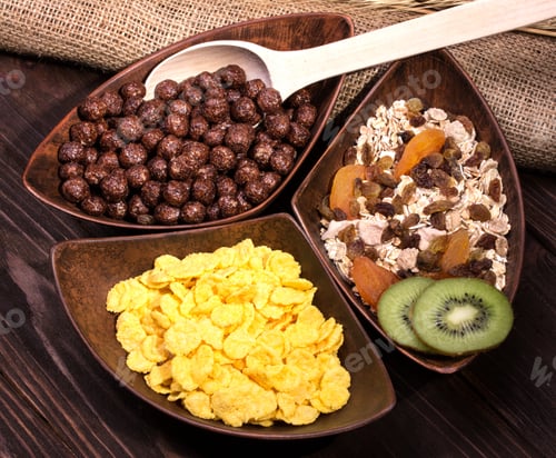 Preview: Assortment Of Different Breakfast With Oatmeal, Cereal, Dried Fruit, Kiwi In Three Plates On A