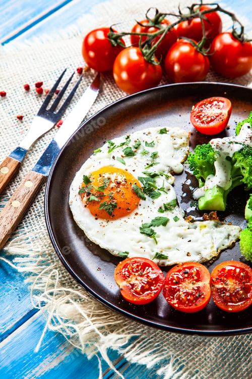 Preview: Fried Egg With Vegetables On Wooden Table
