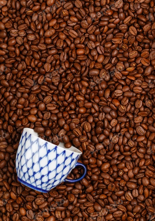 Preview: Roasted Coffee Beans And A White Espresso Cup. Culinary Background. Top View, Selective Focus