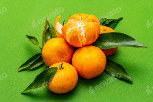 Preview: Ripe Tangerines With Leaves. Fresh Fruits Isolated On Green Background, Close Up