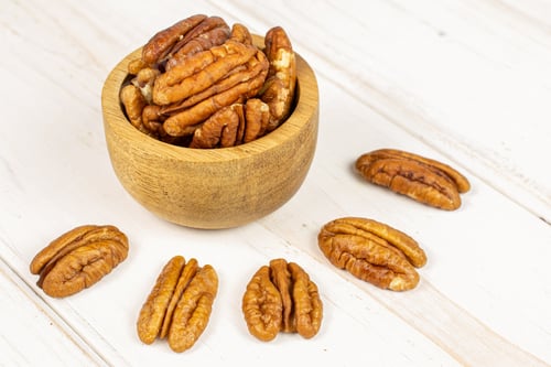 Preview: Lot Of Whole Dry Brown Pecan Nut In Tiny Wooden Bowl On White Wood