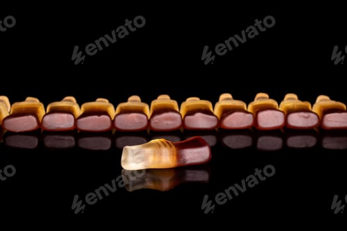 Preview: Lot Of Whole Sweet Jelly Cola Isolated On Black Glass