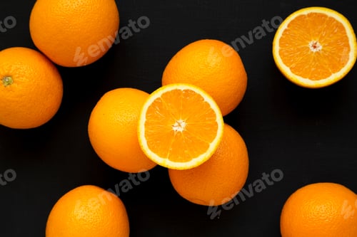 Preview: Fresh Ripe Organic Oranges On A Black Background, Top View. Flat Lay, Overhead, From Above