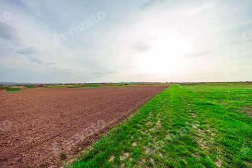Preview: Plowed Field And Cloudy Sky In Sunset