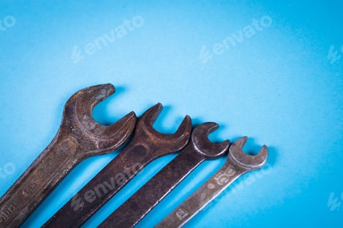 Preview: Some Old Rough Wrench On Blue Background In Studio