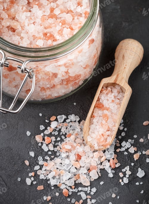 Preview: Himalayan Pink Salt In Wooden Spoon And Jar On A Black Background. Selective Focus