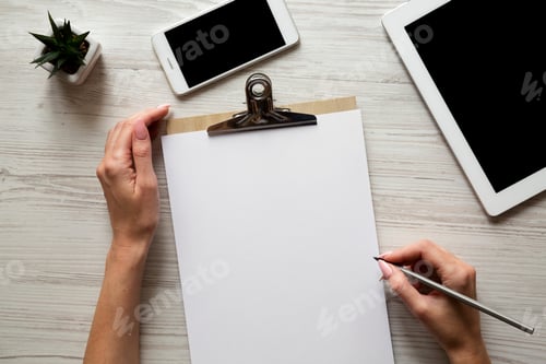 Preview: Workspace With Smartphone, Tablet, Clipboard, Female Hands And Pencil, Overhead. Top View, From