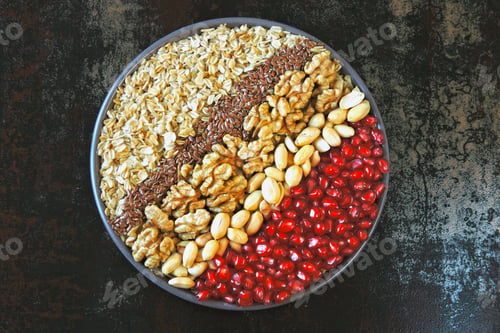 Preview: A Colorful Healthy Breakfast Bowl. A Bowl Of Oatmeal, Nuts, Seeds And Pomegranate Grains