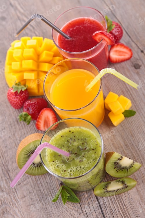 Colorful Fruit Smoothies with Straws on Wood Surface