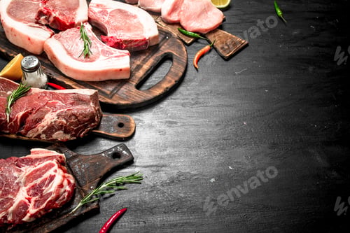 Preview: Different Types Of Raw Pork Meat And Beef With Herb And Spices. On The Black Chalkboard.