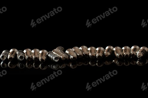 Preview: Lot Of Whole Metallic Glossy Bolt In Row Isolated On Black Glass