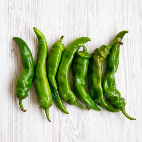 Preview: Green Chili Peppers On White Wooden Background, Top View. Flat Lay, From Above, Overhead. Close-Up.