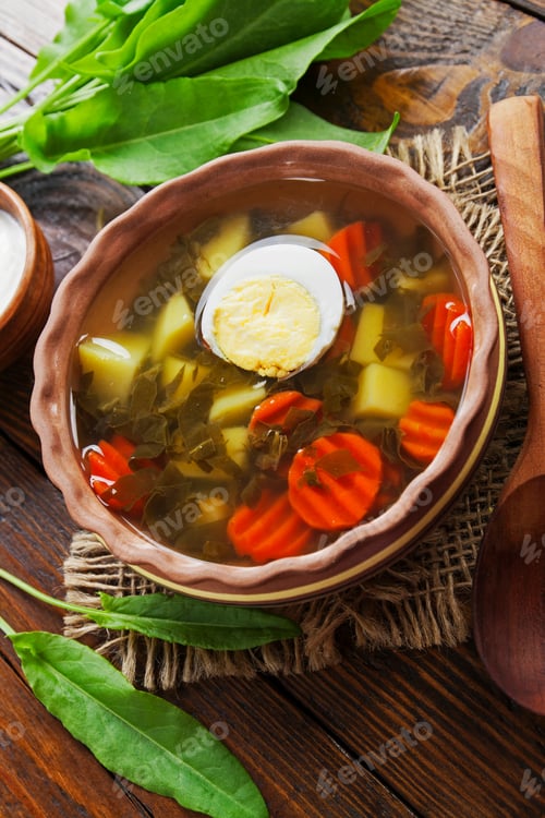 Preview: Sorrel Soup With Egg On Wooden Table