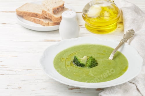 Preview: Broccoli Cream Soup With Olive Oil In A White Plate On A Wooden Table. Dietary Nutrition. Selective