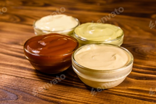 Preview: Different Sauces In Glass Bowls On Rustic Wooden Table