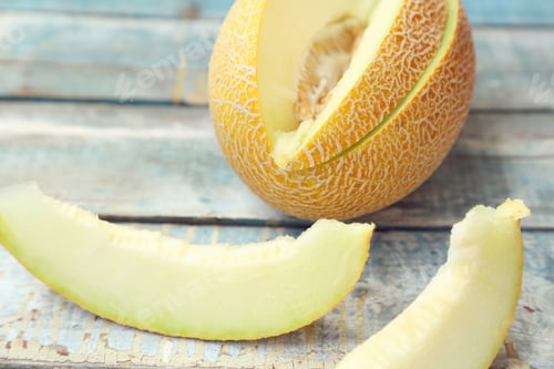 Preview: One Cut Fresh Ripe Melon On A Wooden Background